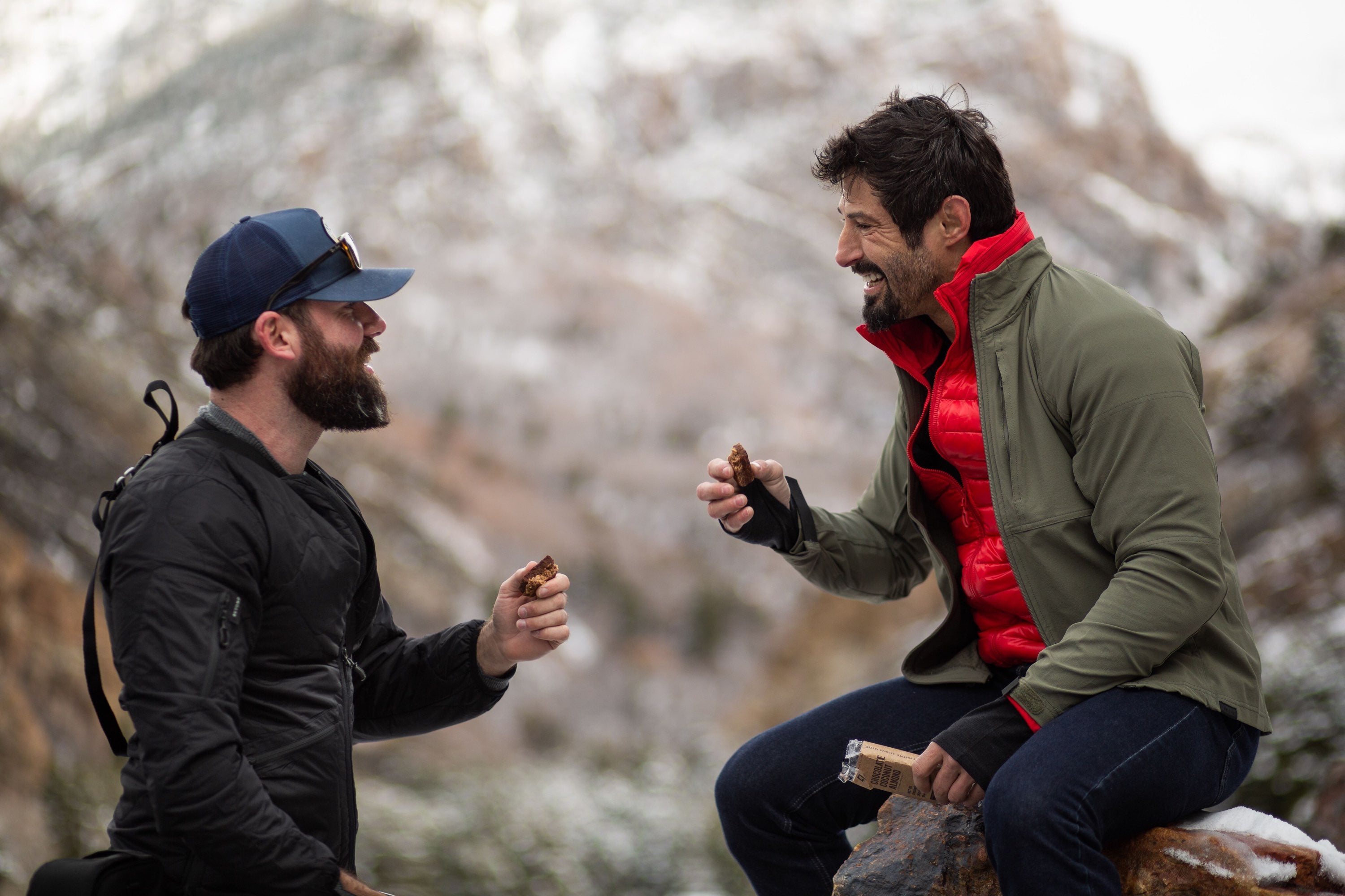 Rudy and Matt sharing a C1 bar on a mountain.