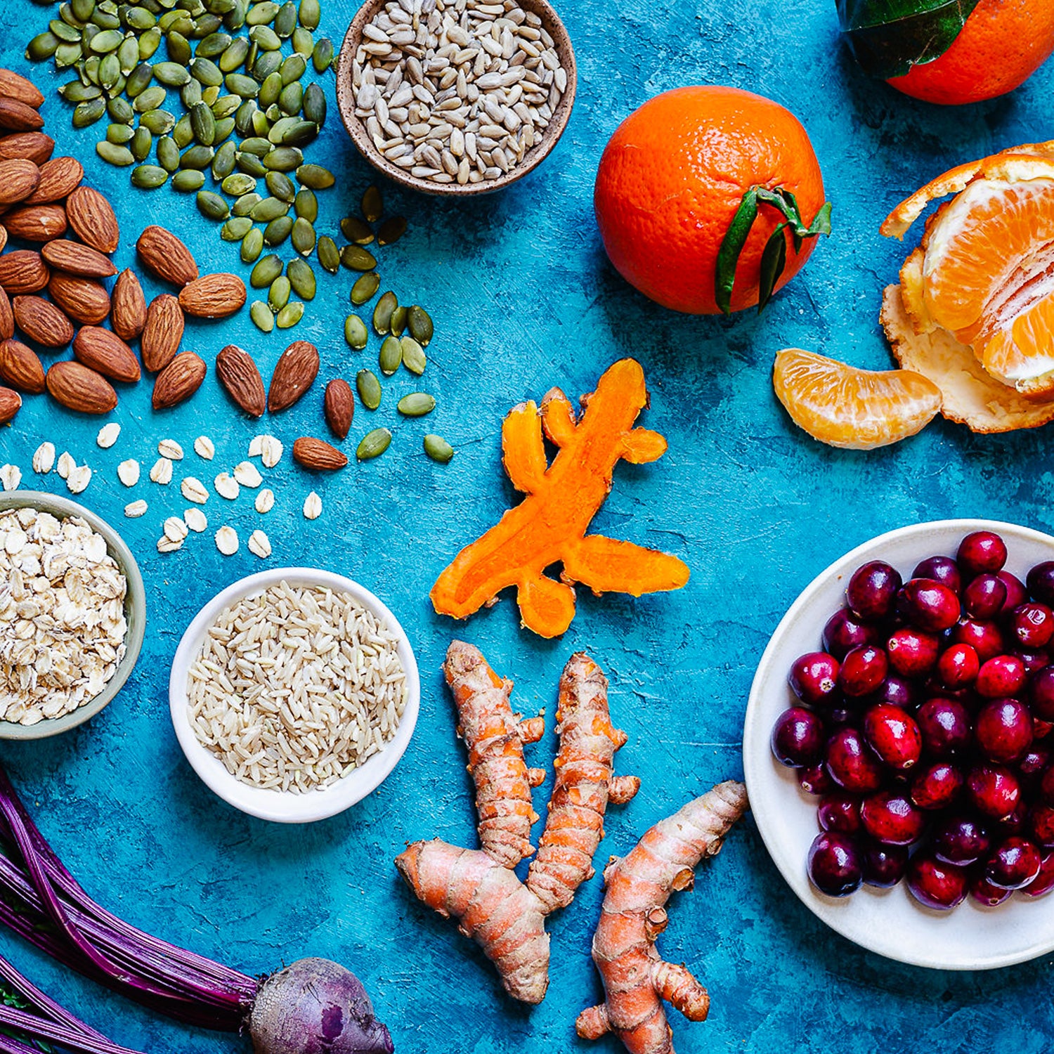 Detail shot of ingredients such as ginger, orange, cranberries, and almonds.
