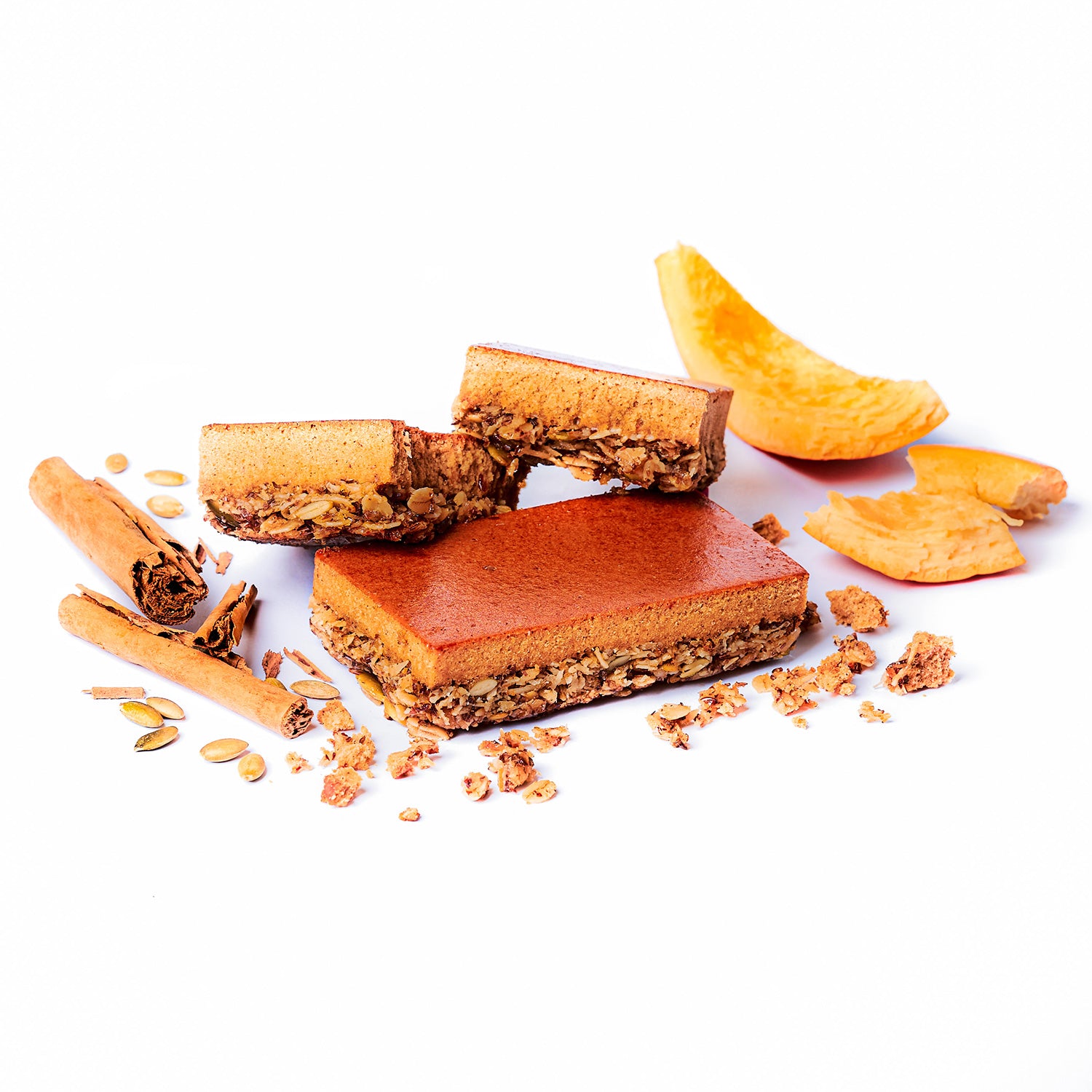 A high-protein nutrition bar with layers visible, showing the pumpkin flavor showing real ingredients such as oats and almonds.