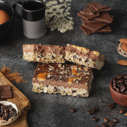 C1's Dark Chocolate Espresso high-protein bars shot around ingredients such as chocolate, coffee beans, oats, eggs, and almonds.