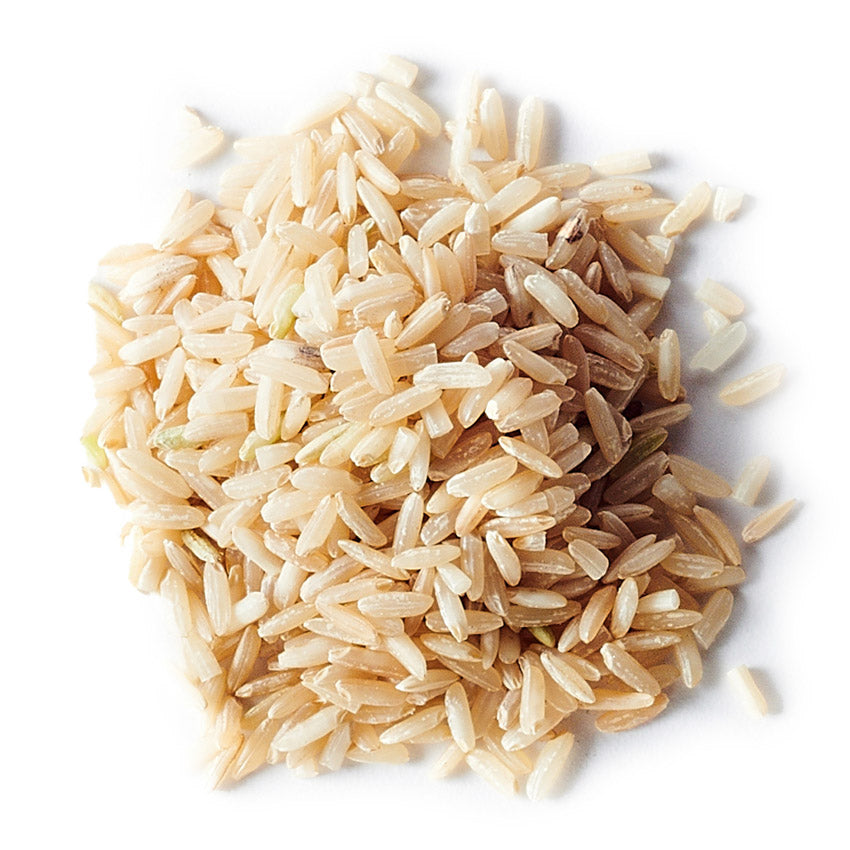 Brown rice grains on a white background