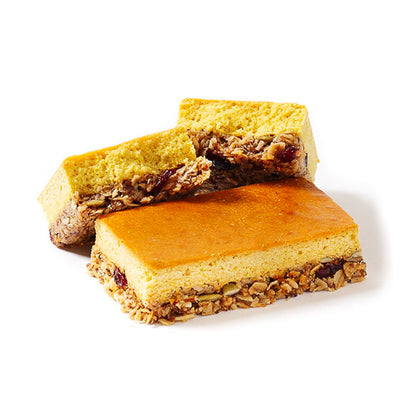 A photo showing a packaged cranberry orange high-protein bar, with visible layers of granola and dried cranberries, against a white background.