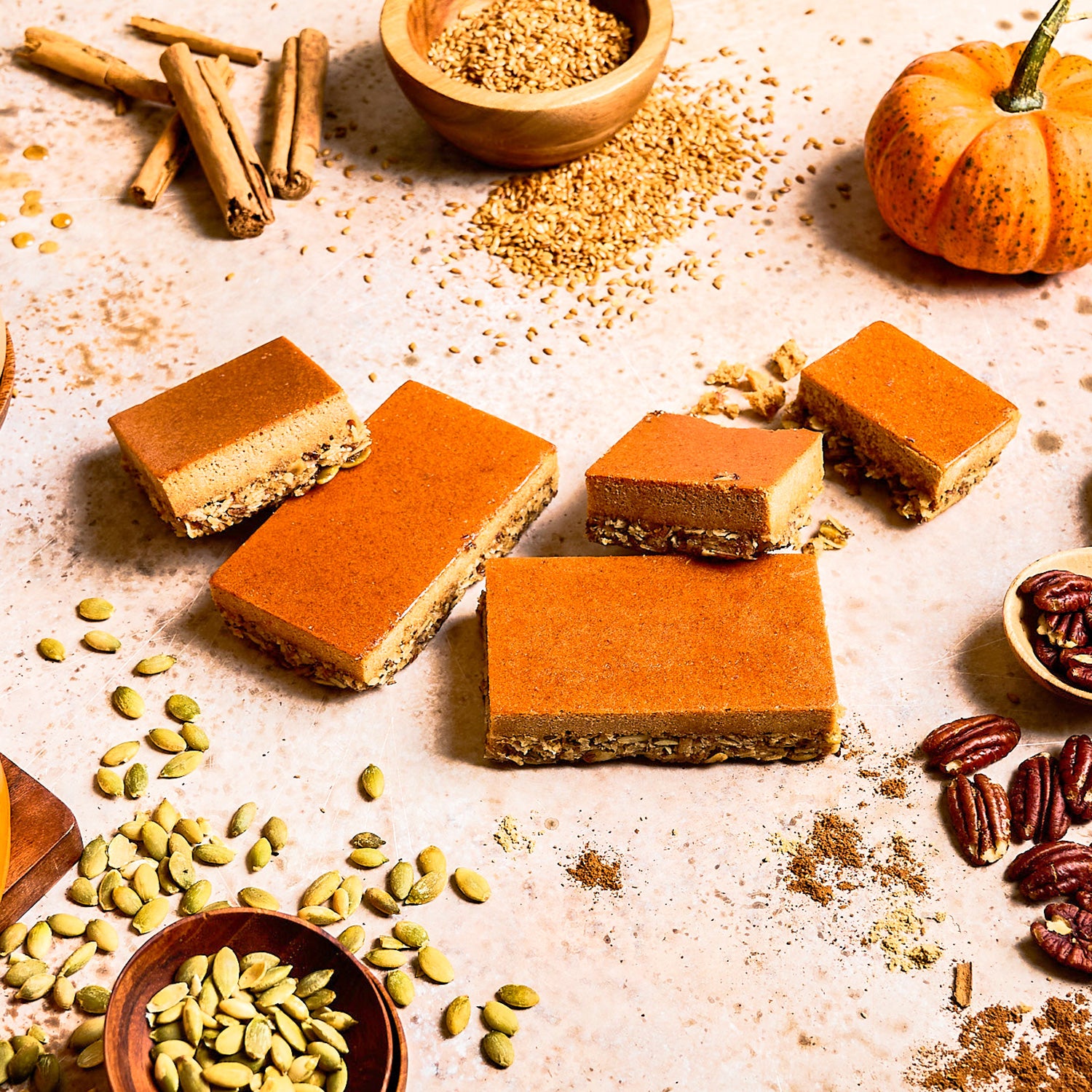 A high-protein nutrition bar with layers visible, showing the pumpkin flavor showing real ingredients such as oats and almonds.