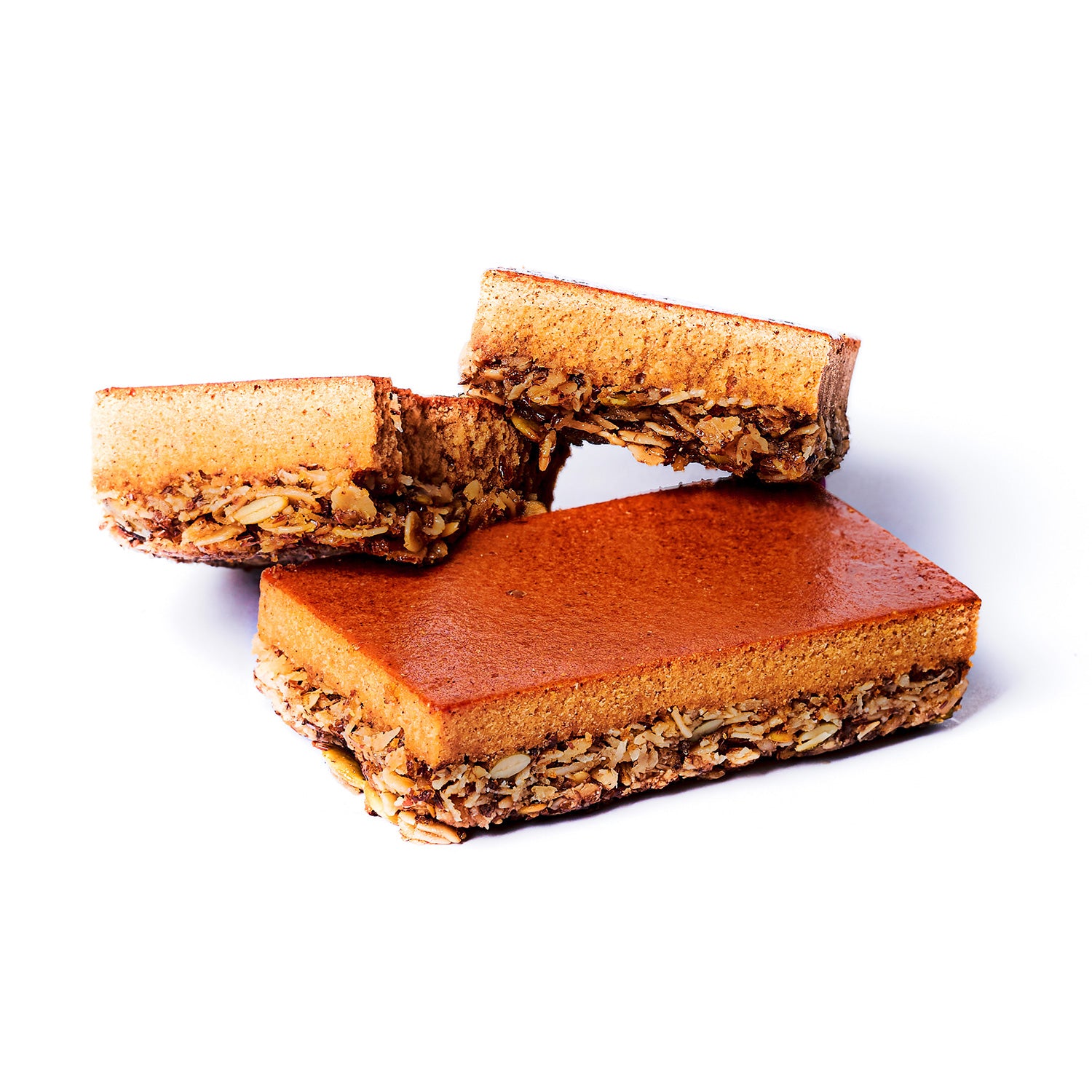 A high-protein nutrition bar with layers visible, showing the pumpkin flavor showing real ingredients such as oats and almonds.